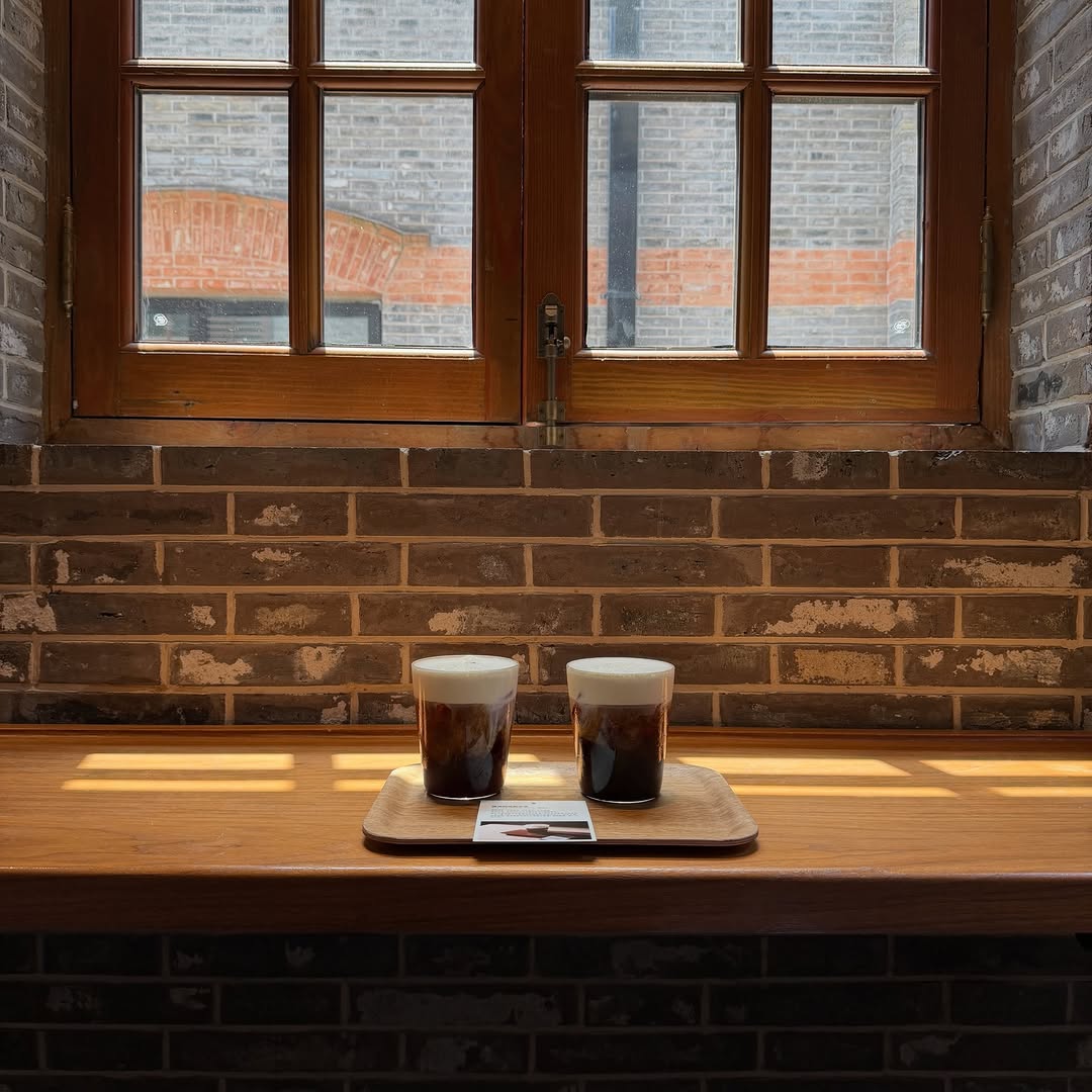 A pour over coffee served in a warm, quiet café setting on a crisp fall morning