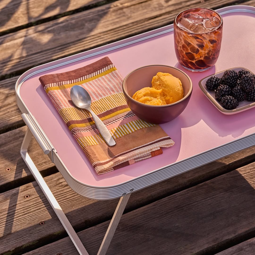 Al fresco-friendly dinnerware and a tiny tray table set for a sunny day outdoors